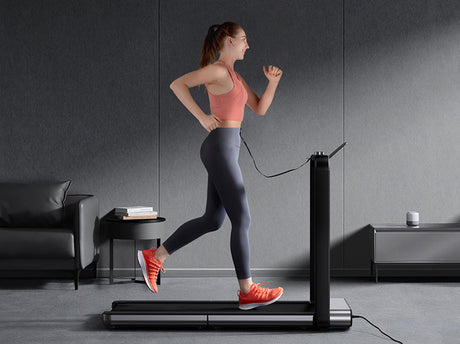 A girl is running on a folding treadmill.