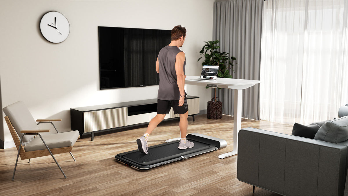 Under-desk treadmill running quietly in a home office